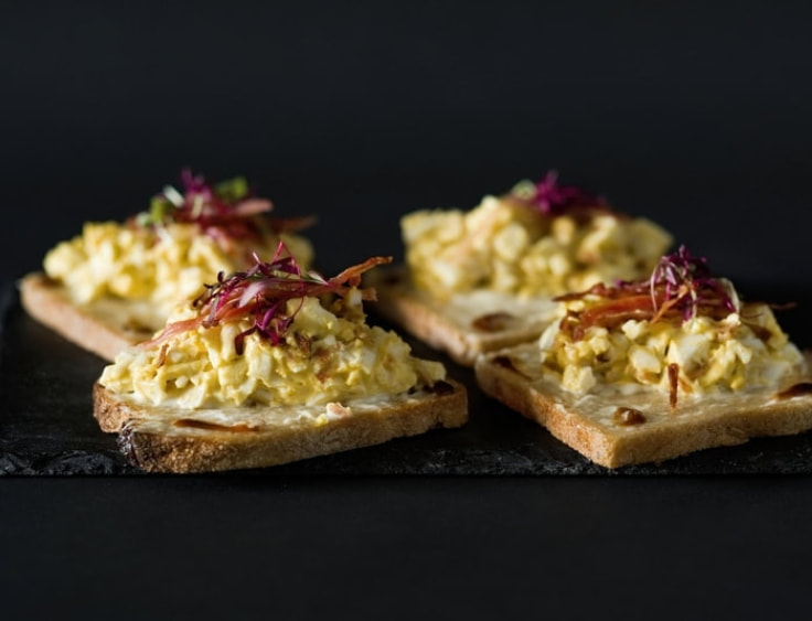 Three toasts with scrambled eggs on them. | The White Leaf 