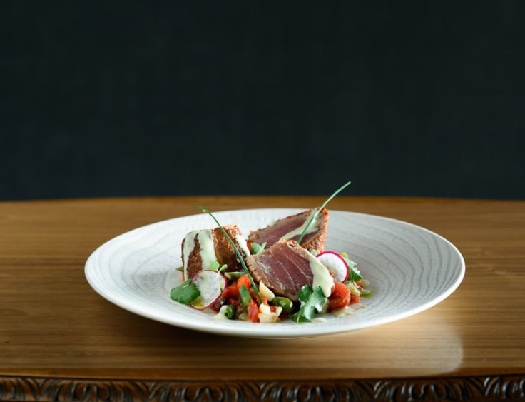 A plate with tuna and vegetables on a wooden table. | The White Leaf 