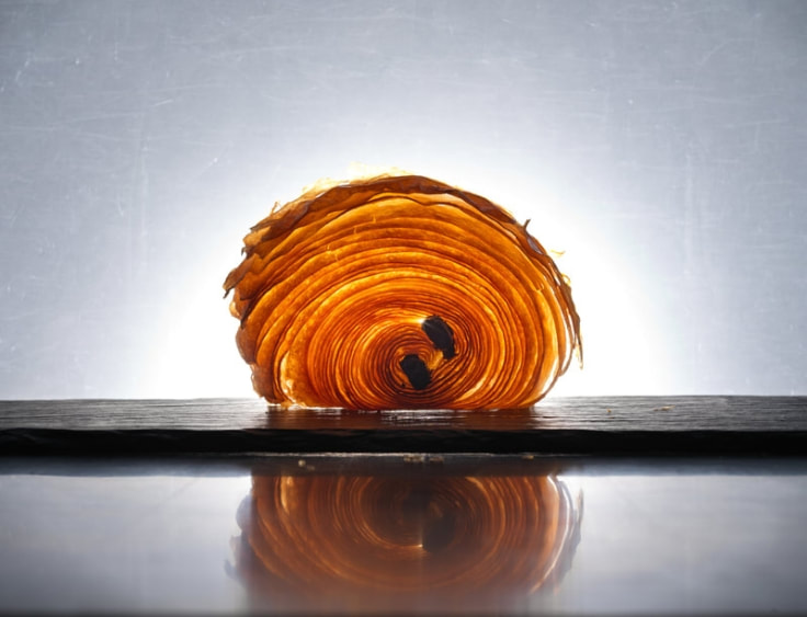 A spiral of pastry sitting on top of a table. | The White Leaf 